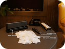 Tabletop setup with heat sealer, dosing tool, and NAVA pouches on a dark surface.